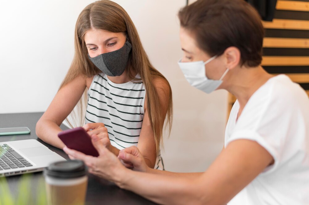 Women at terrace wearing mask